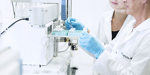 Performing food analysis in the laboratory: laboratory technicians during the examination for residues and contaminants